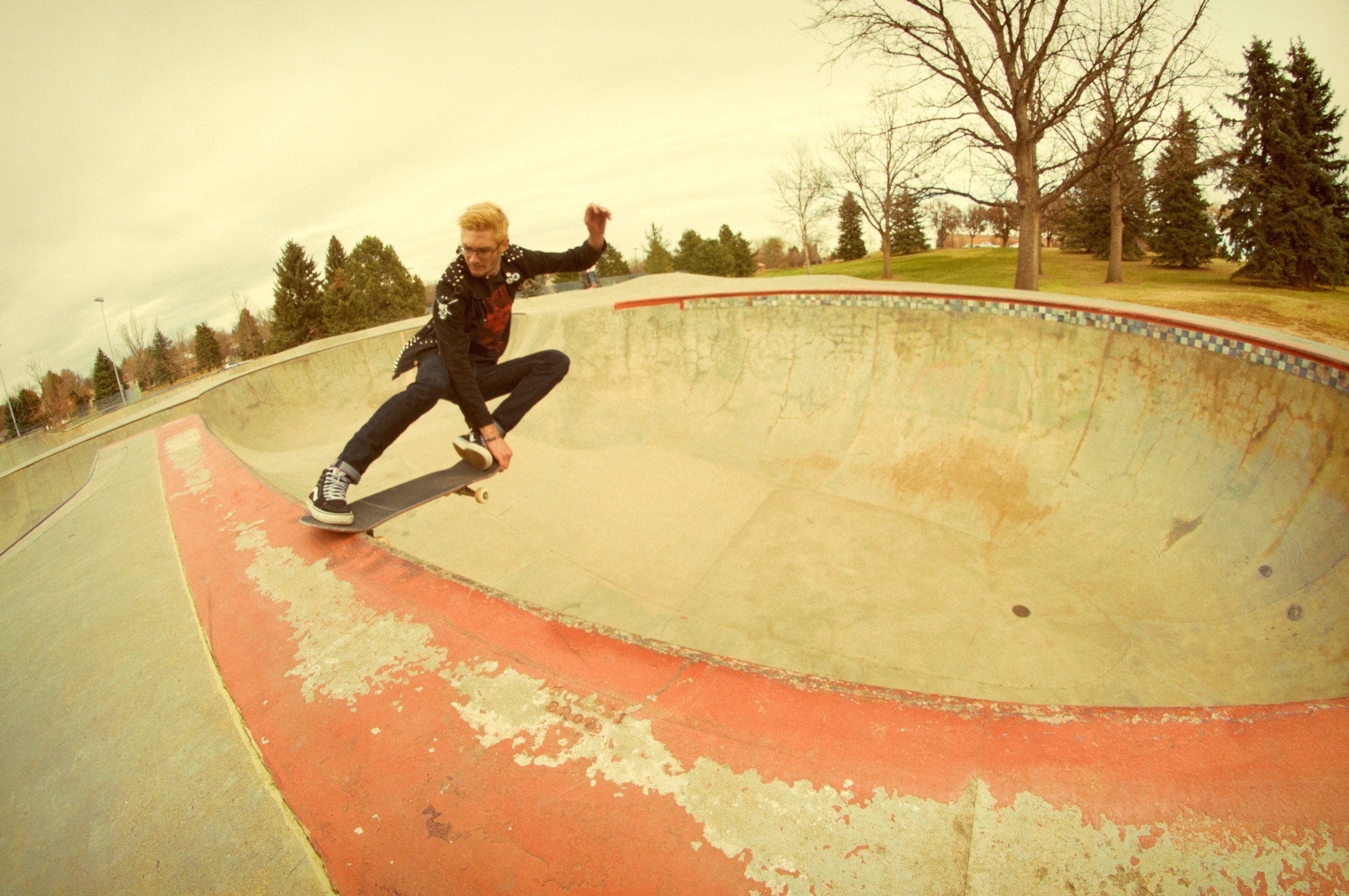A skater carving the bowl at a Fort Collins skatepark